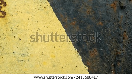 black and yellow lines on concrete.  commonly used as road signs.  yellow black texture