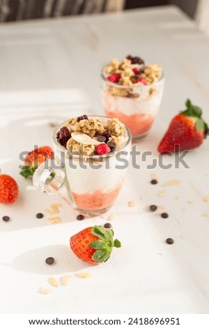 Yogurt with red fruit granola with strawberry cream, almonds and chocolate chips. Healthy snack idea for children.