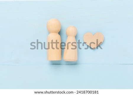 Wooden couple in love on wooden background, top view. Creative valentine's day composition