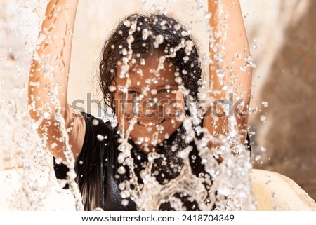 Girl, teenage girl in Brazil playing with water in summer, white background, selective focus.