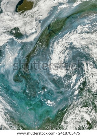 Smoke across central Russia. In lateJuly 2013, wildfires poured thick smoke across central Russia. Elements of this image furnished by NASA. Royalty-Free Stock Photo #2418705475