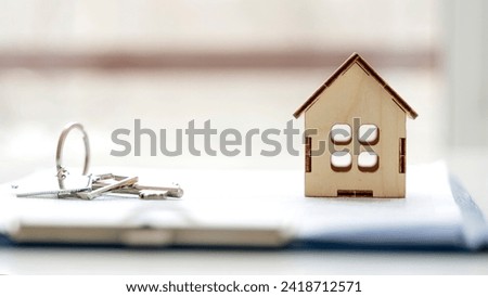 a house with keys on the contract of sale or lease of housing. High quality photo