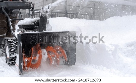a man cleans snow with a snow plow outside. High quality photo