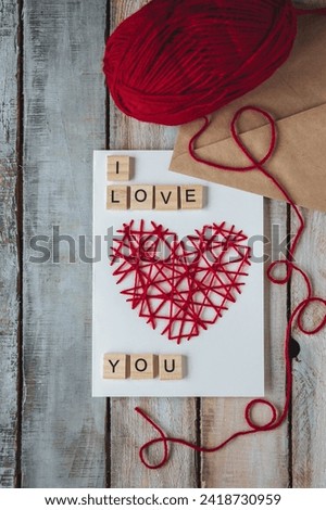 Concept of love message. I love you words written in wooden blocks. Idea for making handmade greeting cards with wooden red heart for Valentine's Day. Sweet cute bear for breakfast, envelope