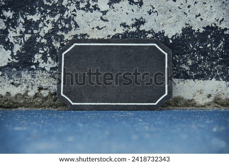 Top view image of empty blackboard sign on textured floor
