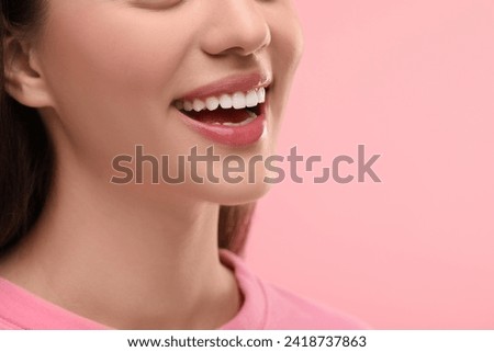 Woman with clean teeth smiling on pink background, closeup. Space for text Royalty-Free Stock Photo #2418737863