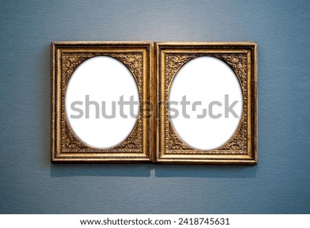 Mockup two white oval blank space in classic gold wooden square louise style frames hanging isolated on light blue luxury background. Empty  oval space on twin vintage vertical rectangular frame.