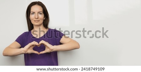 Inspire inclusion. Zoomers symbolize love. Woman finger heart dressed purple t-shirt. Hand showing heart. International Women's Day 2024 banner, inspireInclusion. Royalty-Free Stock Photo #2418749109