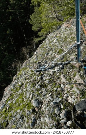 on the rock is a climbing rope with fasteners