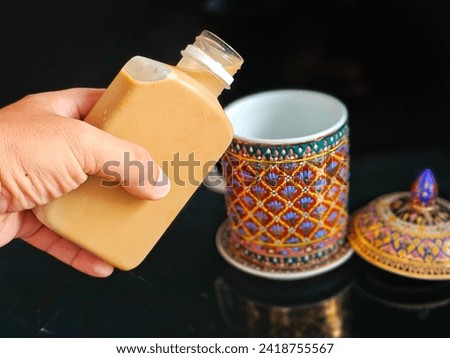 Image of tea being poured into a porcelain glass:Use for website banner background,backdrop
