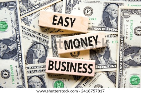 Easy money business symbol. Concept words Easy money business on beautiful wooden blocks. Dollar bills. Beautiful dollar bills background. Easy money business concept. Copy space.