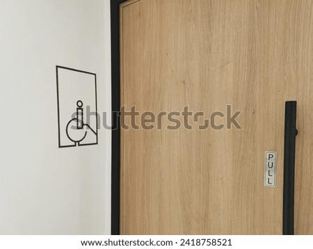 entrance door to a restroom designed for people with disabilities or in a wheelchair. Accessible urban environment.