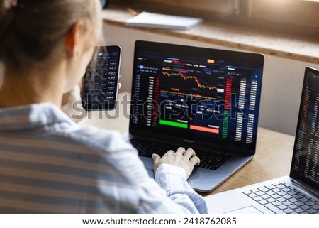 Cryptocurrency concept, investment stock market. Woman Entrepreneur analysis graph stock market trading, stock chart, analysing datum and risks, online trading sitting in the home office