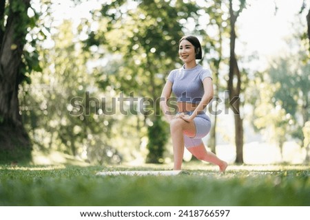 Portrait of young woman practicing yoga in garden.female happiness.  in the park blurred background. Healthy lifestyle and relaxation concept
