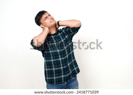 Unhealthy young asian woman touching neck feeling pain and numbness, worried about muscle tension, osteochondrosis. Indoor studio shot isolated on white background