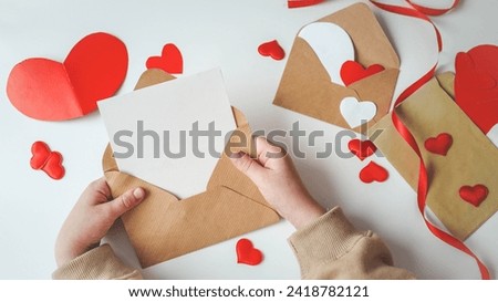 Valentine's Day, a note in a paper heart envelope. Top view. Copy space. Place for text.