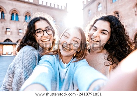 Three smiling young hipster women visit landmarks on vacation in Italy - Happy girls taking selfie self portrait photos on smartphone - Lifestyle concept about female showing positive face emotions