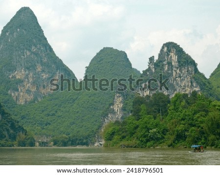When traveling to Yangshuo, China, we took a boat trip on the lake to take pictures of the mountain scenery on the shore