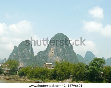 When traveling to Yangshuo, China, we took a boat trip on the lake to take pictures of the mountain scenery on the shore