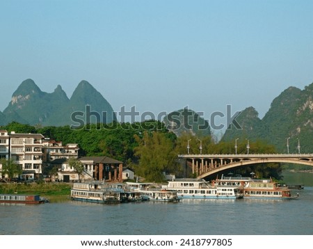 When traveling to Yangshuo, China, we took a boat ride on the lake to take pictures of the mountain scenery and houses on the shore