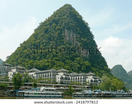 When traveling to Yangshuo, China, we took a boat ride on the lake to take pictures of the mountain scenery and houses on the shore