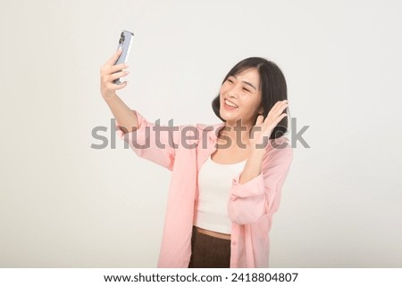 Young asian woman using smartphone over white background, technology concept