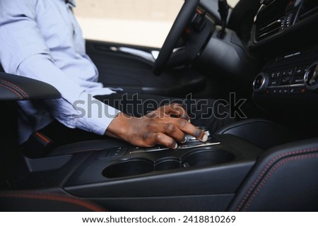 A man's hand on a Gear shift close up.