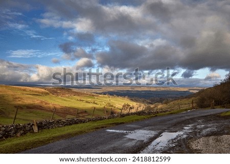 View looking north towards Wensleydale across West Burton from the single tracked road to Walden in North Yorkshire