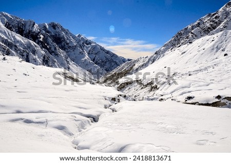 This is an image of Kedarnath valley in Uttarakhand, India. The image was taken during the winter months when the portals of the Kedarnath temple remained close due to heavy snowfall. Royalty-Free Stock Photo #2418813671