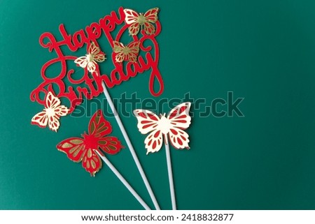 Letters with paper butterflies wishing a happy birthday on a green background red letters and areas of white light hitting the background Add dimension to the image Suitable for wallpaper