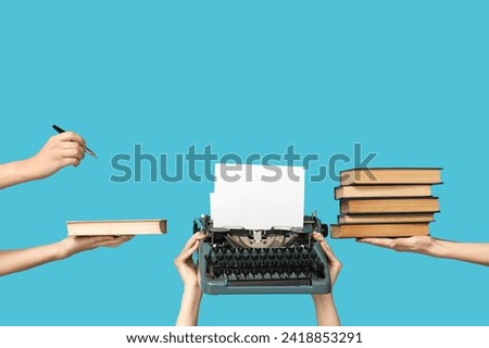 Women with vintage typewriter and books on blue background
