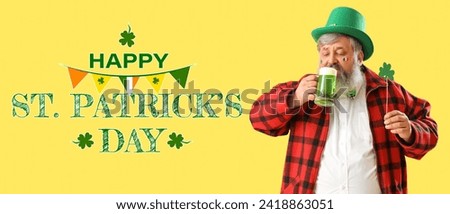 Funny bearded man in leprechaun's hat drinking beer on yellow background. Banner for St. Patrick's Day