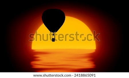 Silhouette of hot air balloon over large sun disk and ocean. Beautiful setting sun over sea with waves, big air balloon flying in the sky. Royalty-Free Stock Photo #2418865091