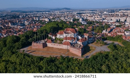 Landscape photography of the modern star shaped fortification in Brasov, Romania. Photography was taken from a drone at a higher altitude with camera level for a panoramic still of the bastion.