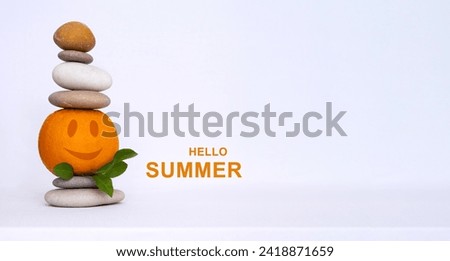 Stack of pebbles with funny orange on white background. Hello summer copy space