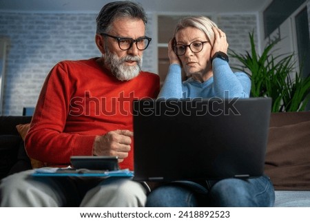 Couple upset headache depressed from family cost got higher doing accounting holding receipts from supermarket with calculator rising grocery prices and surging cost as an inflation financial crisis Royalty-Free Stock Photo #2418892523