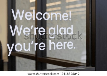 Welcome sign at the storefront. Royalty-Free Stock Photo #2418896049