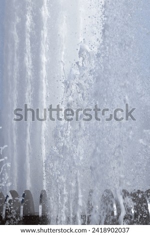 Wet spray summer waterfall background.