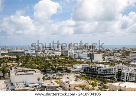 Aerial drone photoshoot Footage in Florida, USA, commercial area, luxury houses, buildings and mansions, abundant tropical vegetation around, beautiful blue sky.