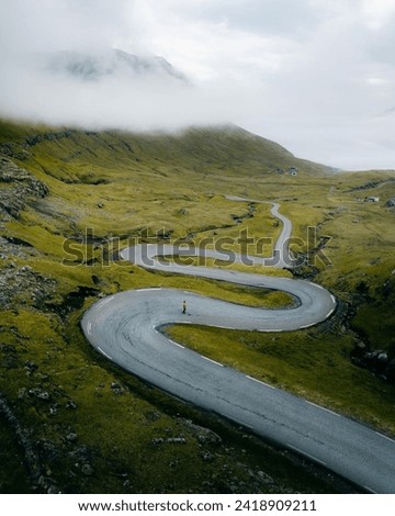 A Winding Road In The Faroe Islands Denmark  Royalty-Free Stock Photo #2418909211
