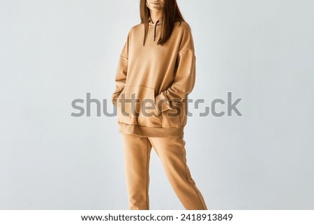 Cozy and Chic in a Beige Hoodie. A Minimal and Modern Style for Casual Fashionistas. Logo and branding design mock-up