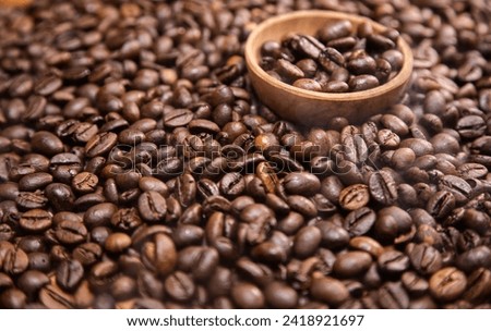 Close up view of roasted coffee beans in wooden bowl the end of the frame, panoramic shot