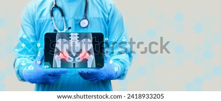 Pain in the cartilage joints, femoral head. Pelvis, degenerative hip disease. Inflammation due to arthritis and osteoarthritis. The pelvis x-ray is shown on the doctor's tablet. Royalty-Free Stock Photo #2418933205