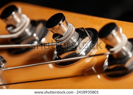 guitar headstock tuning post macro closeup Royalty-Free Stock Photo #2418935801