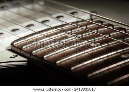 electric guitar fretboard body macro closeup Royalty-Free Stock Photo #2418935817