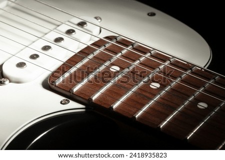 electric guitar fretboard body macro closeup Royalty-Free Stock Photo #2418935823