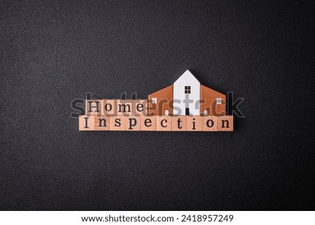 The inscription Home inspection made of wooden cubes on a plain background. Can be used for your design