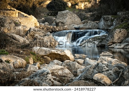 Waterfall formed by the Salor river, at its entrance to the El Gallo reservoir, in Extremadura, Spain. Long exposure photography