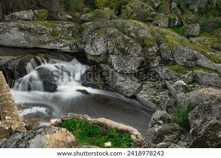 Waterfall formed by the Salor river, at its entrance to the El Gallo reservoir, in Extremadura, Spain. Long exposure photography