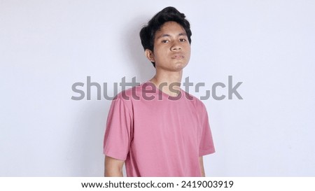 Handsome Asian man with a thin smile poses coolly on a white background Royalty-Free Stock Photo #2419003919